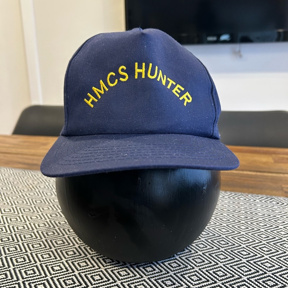 Adult size HMCS HUNTER SnapBack hat. Navy blue, embroidered yellow lettering.